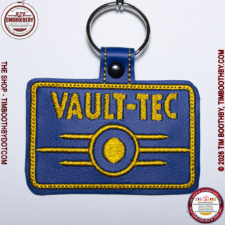 Blue rectangle key chain with a Game Logo on it.